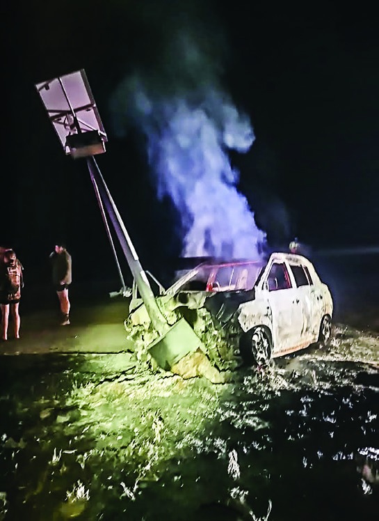 Smoke rises from the burnt-out vehicle following Friday evening’s crash at the Makoppa junction on the Dwaalboom road.